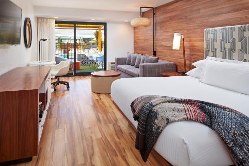 a hotel room with a bed and a living room at Carmel Mission Inn in Carmel