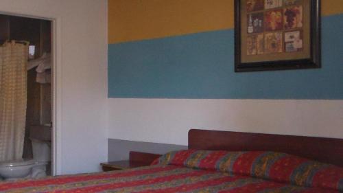 a bedroom with a bed and a blue and white wall at Laurel Inn in Oakland