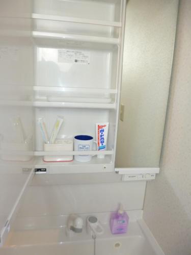 a refrigerator with its door open and a sink at THE MICKEY CARLTON Ohashi 206 in Shiobaru