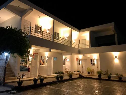 a large white building with lights on at Albergo El Pulpo, Bayahíbe in Bayahibe
