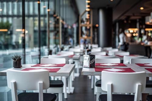 a row of tables and chairs in a restaurant at Best Western Plus Net Tower Hotel Padova in Padova