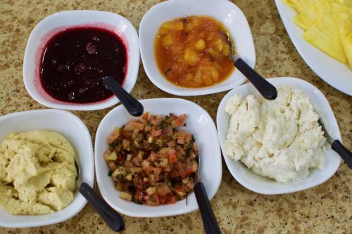 a table topped with bowls of different types of food at Pepe's House Cuenca I Hotel & Boutique Hostel in Cuenca