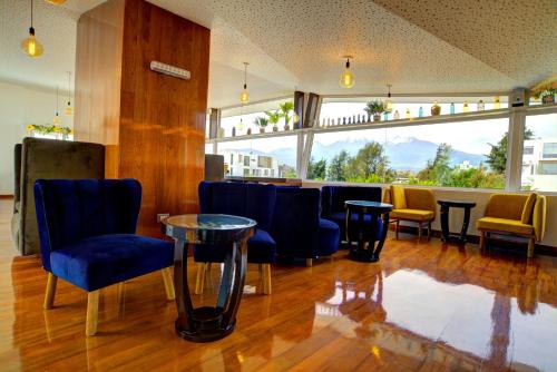 a waiting room with blue chairs and a table at Mint Hotel in Arequipa