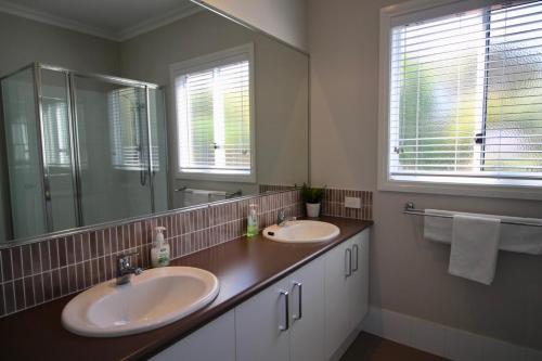a bathroom with two sinks and a large mirror at Flinders View in Augusta