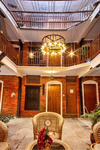 a large room with a chandelier and wicker chairs at Newa Home in Kathmandu