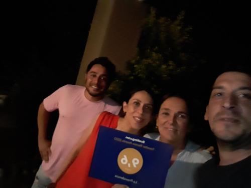 a group of people posing for a picture with a sign at La Providencia in Yerba Buena