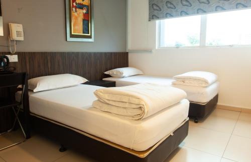 a hospital room with two beds and a window at M Design Hotel @ Pandan Indah in Kuala Lumpur