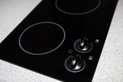 a black remote control with two knobs on it at St Ives Apartments in Hobart