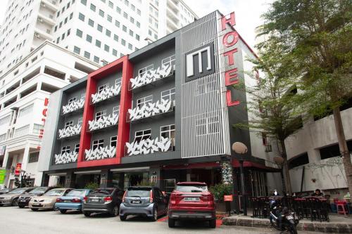 a building with cars parked in front of it at M Design Hotel @ Pandan Indah in Kuala Lumpur