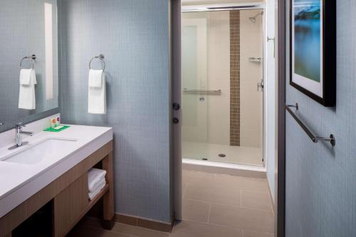 a bathroom with a sink and a shower at Hyatt Place Mount Pleasant Towne Centre in Charleston