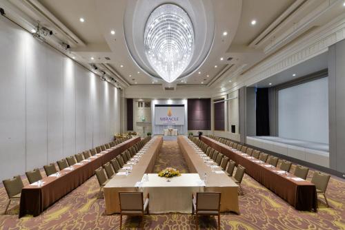 a large banquet hall with tables and chairs at Miracle Grand Convention Hotel in Bangkok