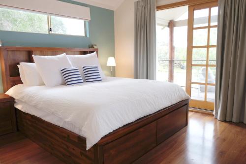 a bedroom with a large bed with white sheets and pillows at Sea Esta - town & beach on your doorstep in Dunsborough
