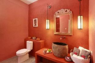 a red bathroom with a toilet and a mirror at PinkCoco Gili Trawangan - Constant Surprises - for Cool Adults Only in Gili Trawangan