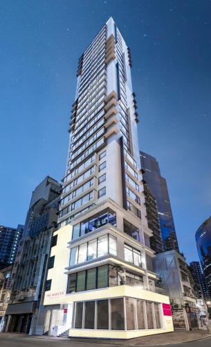 a tall white building with a lot of windows at The Mercer in Hong Kong