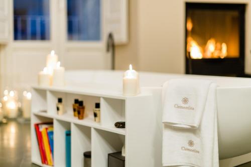a bathroom with a counter with towels and candles at Dimora Clementina in Putignano