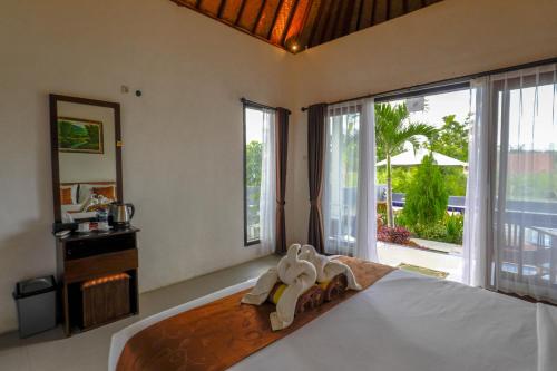 un dormitorio con una cama con toallitas. en Tunjung Kuning Cottage, en Nusa Penida