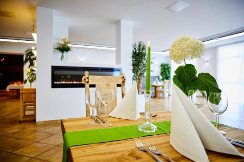 a table with a green table cloth and wine glasses at Sonnenhof in Dietzenbach