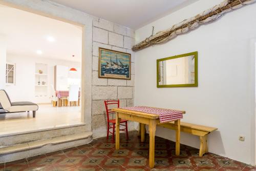 a dining room with a wooden table and chairs at Heritage House Captain Bepo's Court in Sumartin