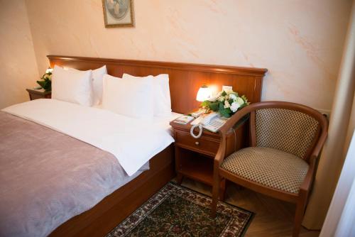 a bedroom with a bed and a desk and a chair at Danilovskaya Hotel in Moscow