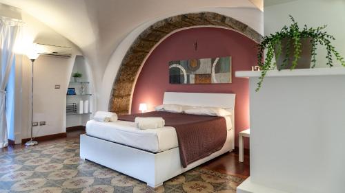 a bedroom with a bed and a red wall at The House in Catania