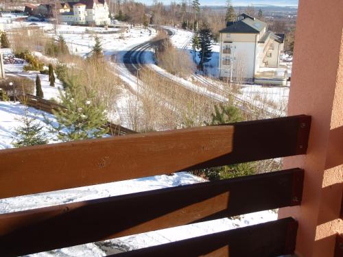 a view from a balcony of a snow covered street at Penzion Partizan in Smokovce