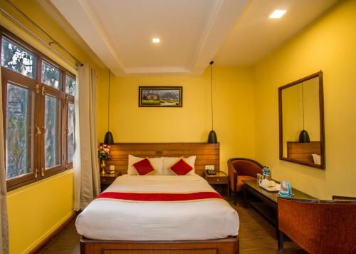 a bedroom with a large bed and a large window at Hotel Blue Horizon in Kathmandu