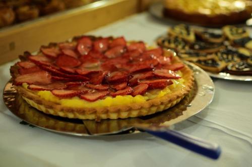 a pie with bacon on top of a table at Hotel Marina in Marina di Massa