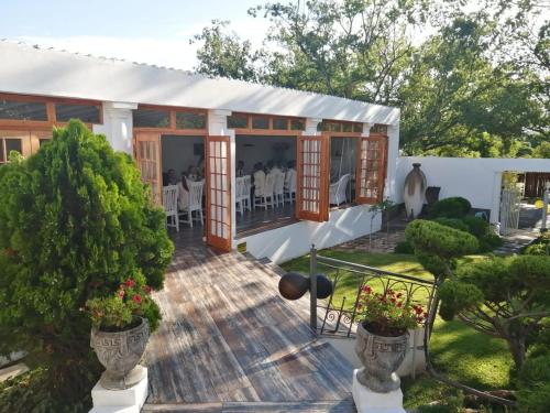 a house with a deck with tables and chairs at De Witte Huis in Bethlehem