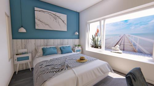 a bedroom with a bed and a large window at Nerja Casual Rooms in Nerja