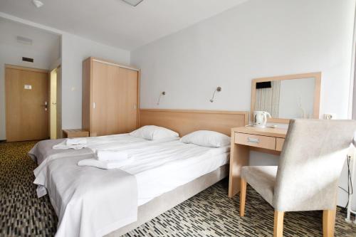 Ένα ή περισσότερα κρεβάτια σε δωμάτιο στο Geovita Dźwirzyno