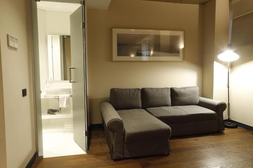a living room with a couch and a mirror at Bankerhan Hotel Galata - Adults Only Special Category in Istanbul