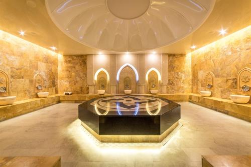 a large bathroom with toilets in a large room at Sky Blue Hotel & Spa in Ploieşti