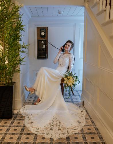 a woman in a wedding dress sitting in a hallway at Avalon House Hotel in Castlecomer