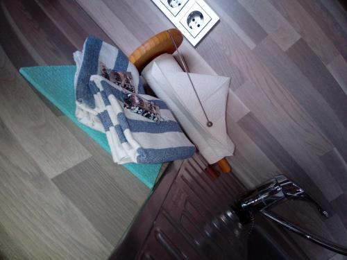 a table with towels on top of a wooden floor at Haus Strandburg Amrum in Wittdün