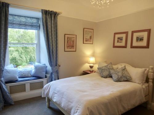 una camera con letto e finestra di Riverbank House Bed and Breakfast Innishannon a Inishannon