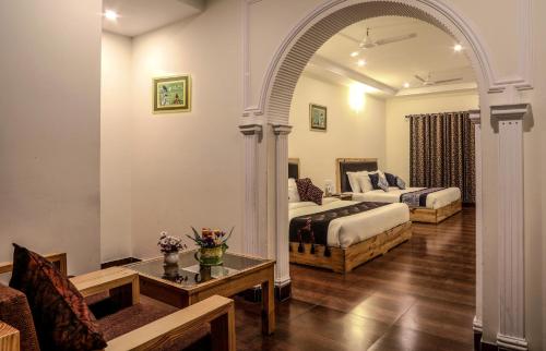 an arched room with a bed and a couch at Hotel SunGrace in Mussoorie