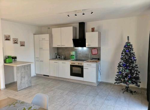 a kitchen with a christmas tree in the corner at Modern Wohnen I Parkplatz I Wlan I Netflix I Balkon I 6 Schlafplätze in Bad Oeynhausen
