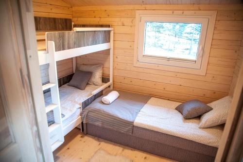 a bedroom with two bunk beds and a window at YACHT CLUB WEJSUNY in Ruciane-Nida