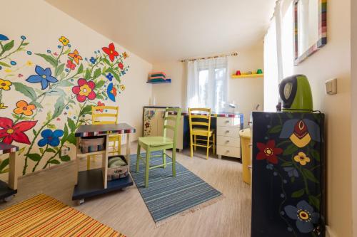 a room with a classroom with a flower mural on the wall at City Center Garden Camping in Tallinn