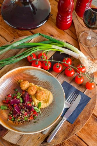 a bowl of food on a wooden table with a plate of food at Radisson Blu Resort & Spa in Split