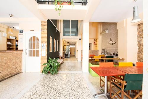 a room with tables and chairs in a building at Safestay Athens Monastiraki in Athens
