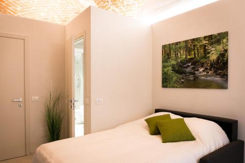 1 dormitorio con 1 cama con una pintura en la pared en Mameli Comfort en Casale Monferrato