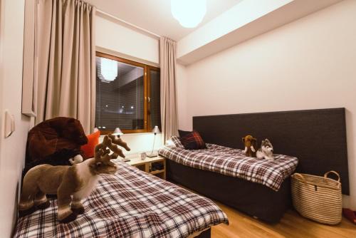 a bedroom with two beds and stuffed animals on the bed at Yllas Chalet VIII 8105 in Ylläs