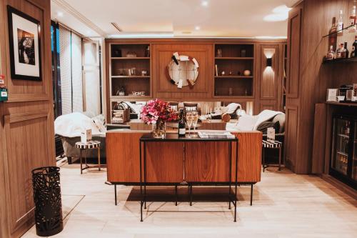 a living room with a table with flowers on it at Waldorf Montparnasse in Paris