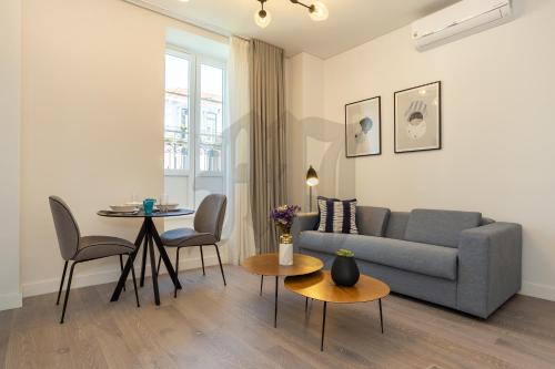 a living room with a couch and a table at Morgan-Jupiter Apartments in Lisbon