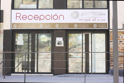 a store front with glass doors and a sign on it at Apartamentos Gorbea Suites in Sierra Nevada