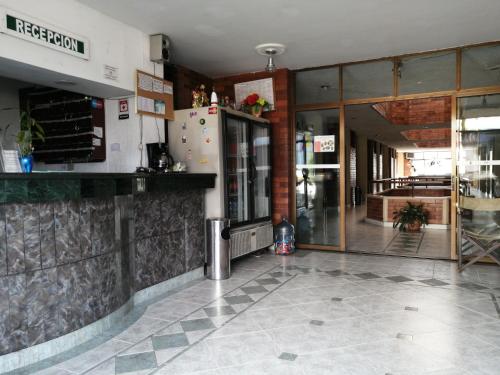 a lobby of a restaurant with a refrigerator at LA POSADA DEL VIAJERO in Ibagué