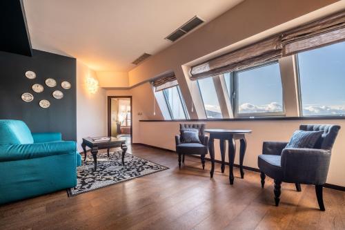 a living room with a blue couch and chairs at Chateau Appony in Oponice
