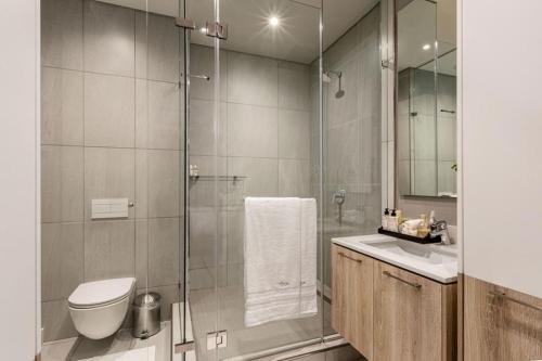a bathroom with a shower and a toilet and a sink at Menlyn Maine Residence Unit 1419 in Pretoria
