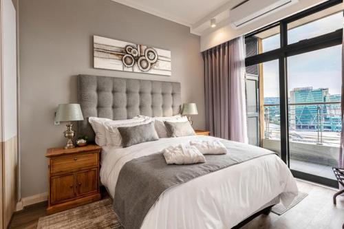 a bedroom with a large bed with a large window at Menlyn Maine Residence Unit 1419 in Pretoria